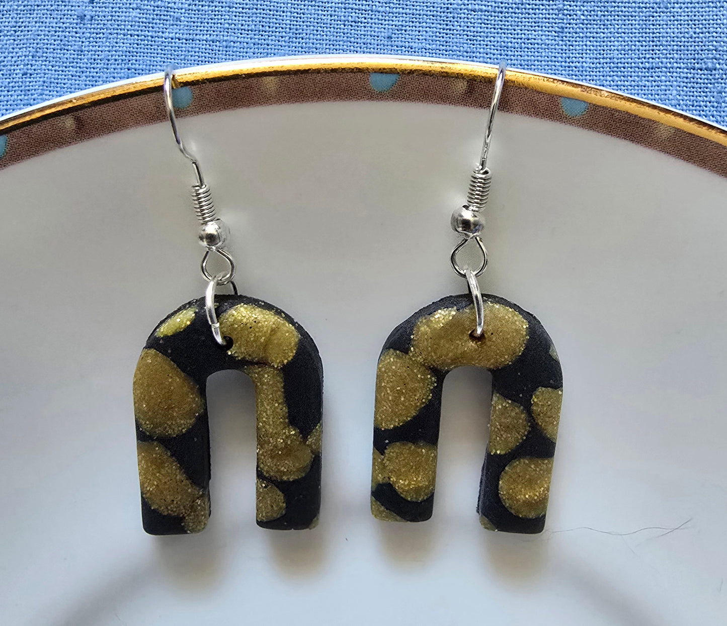 Black and gold arch earrings